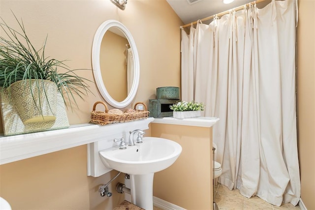full bath with toilet, curtained shower, and tile patterned flooring