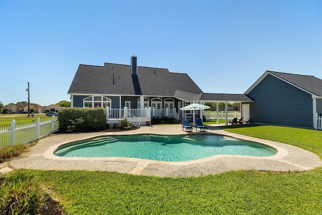 view of pool featuring a fenced in pool, a patio, a wooden deck, fence, and a lawn