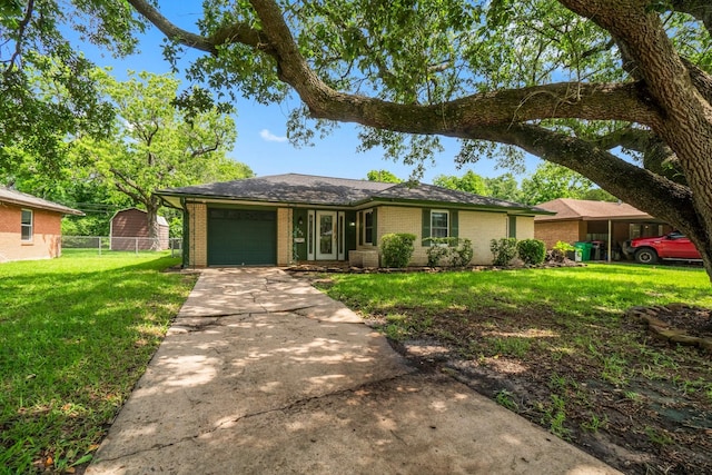 1702 Sheridan Dr, Baytown, TX 77520 - ranch-style home with brick siding, a garage, and driveway