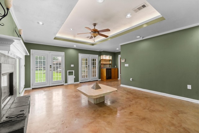 1702 Sheridan Dr, Baytown, TX 77520 - unfurnished living room featuring french doors, a raised ceiling, recessed lighting, finished concrete flooring, and baseboards