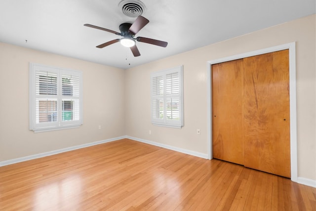 1702 Sheridan Dr, Baytown, TX 77520 - unfurnished bedroom with multiple windows, light wood-style floors, baseboards, and a closet