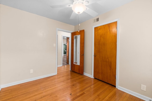 1702 Sheridan Dr, Baytown, TX 77520 - unfurnished bedroom featuring light wood-style flooring, baseboards, ceiling fan, and a closet