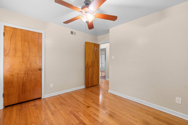 1702 Sheridan Dr, Baytown, TX 77520 - unfurnished bedroom with wood-type flooring, baseboards, and ceiling fan