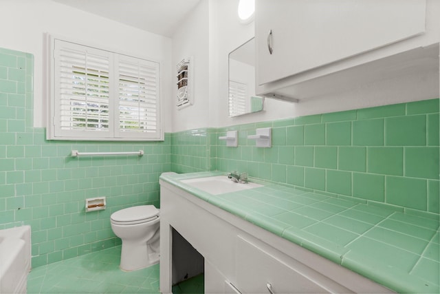 1702 Sheridan Dr, Baytown, TX 77520 - bathroom with toilet, tile patterned flooring, vanity, a wainscoted wall, and tile walls