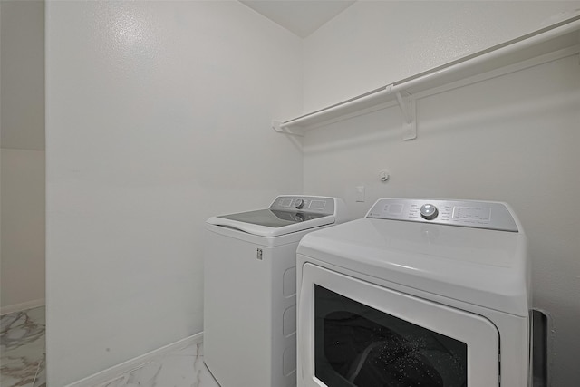 7727 N Friesian Meadow Ln NW, Humble, TX 77338 - laundry room featuring light marble finish flooring and washer and clothes dryer