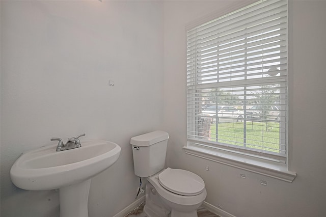 7727 N Friesian Meadow Ln NW, Humble, TX 77338 - half bathroom featuring baseboards and toilet