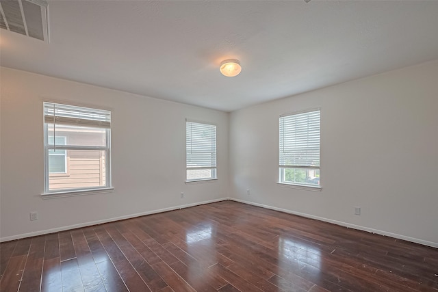 7727 N Friesian Meadow Ln NW, Humble, TX 77338 - unfurnished room featuring baseboards and dark wood-style floors