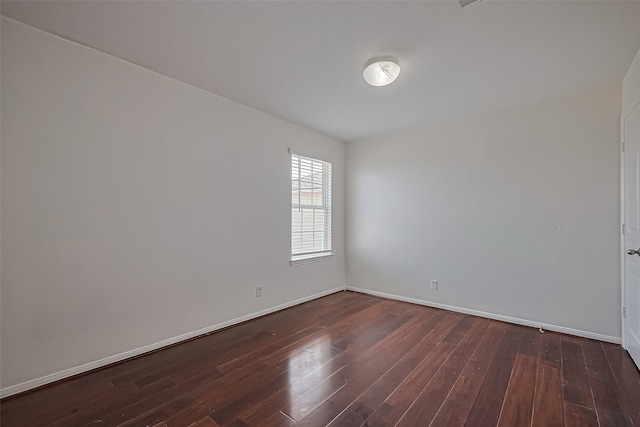 7727 N Friesian Meadow Ln NW, Humble, TX 77338 - spare room featuring dark wood-type flooring and baseboards