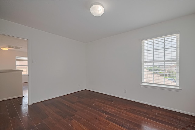 7727 N Friesian Meadow Ln NW, Humble, TX 77338 - empty room featuring dark wood finished floors and healthy amount of natural light