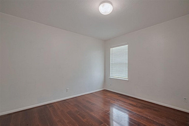 7727 N Friesian Meadow Ln NW, Humble, TX 77338 - spare room with dark wood finished floors and baseboards