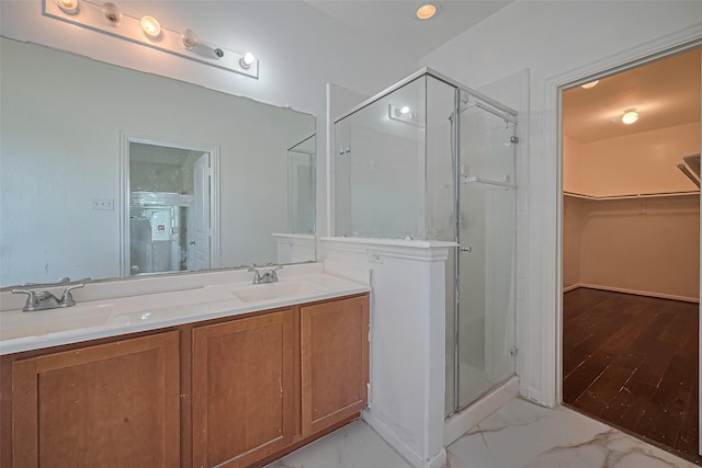 7727 N Friesian Meadow Ln NW, Humble, TX 77338 - bathroom featuring a stall shower, a walk in closet, and double vanity