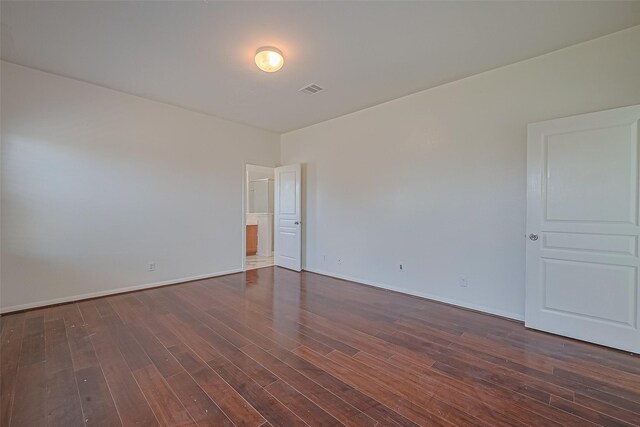 7727 N Friesian Meadow Ln NW, Humble, TX 77338 - empty room with dark wood finished floors and baseboards