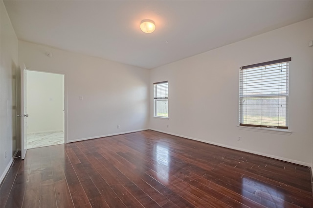 7727 N Friesian Meadow Ln NW, Humble, TX 77338 - empty room featuring dark wood finished floors and baseboards