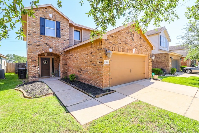 traditional-style home featuring a front lawn, concrete driveway, fence, a garage, and brick siding