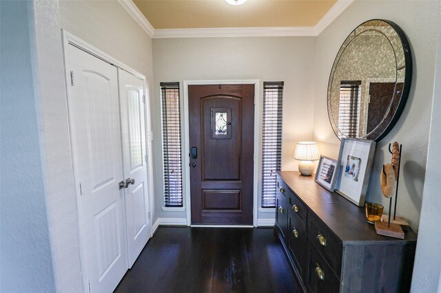 foyer featuring baseboards, dark wood-type flooring, and ornamental molding