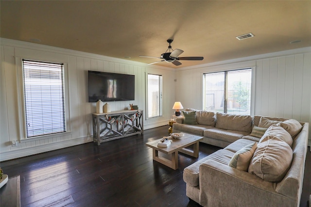 living room with visible vents, hardwood / wood-style flooring, ceiling fan, and a healthy amount of sunlight