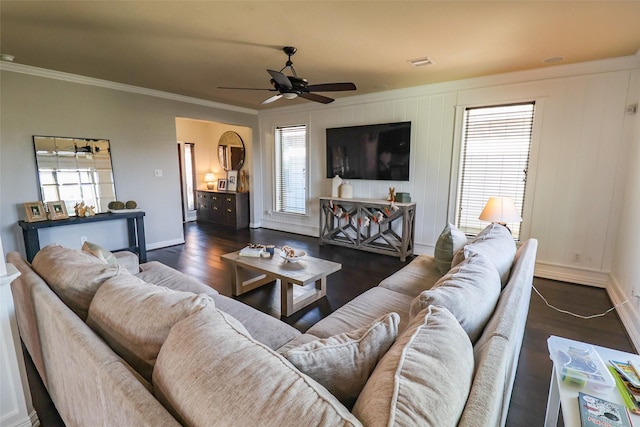 living room with wood finished floors, crown molding, baseboards, and a ceiling fan