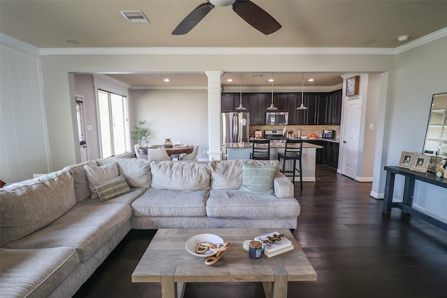 living area featuring baseboards, visible vents, a ceiling fan, crown molding, and dark wood-type flooring