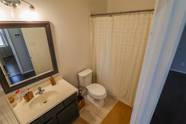 full bath with toilet, a shower with shower curtain, vanity, and tile patterned floors