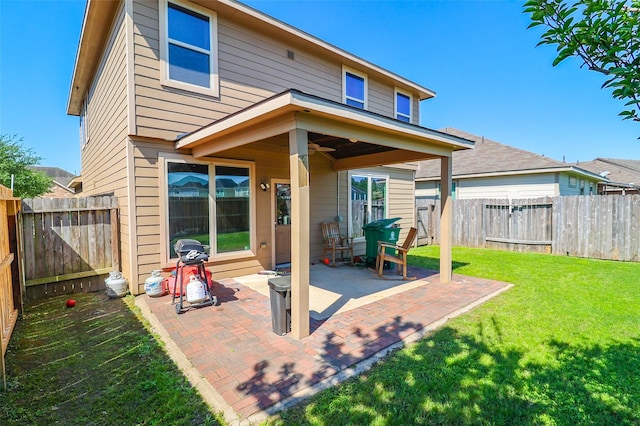 back of house with a fenced backyard, a yard, and a patio