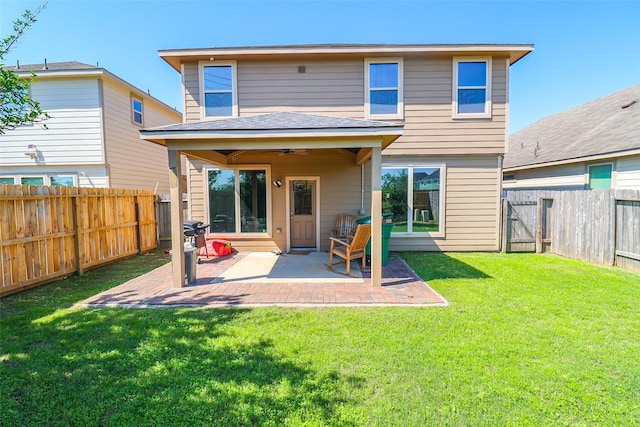 back of house with a lawn, a patio, a fenced backyard, and ceiling fan