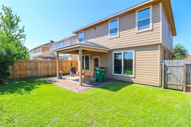 rear view of property featuring a fenced backyard, a gate, a yard, and a patio area