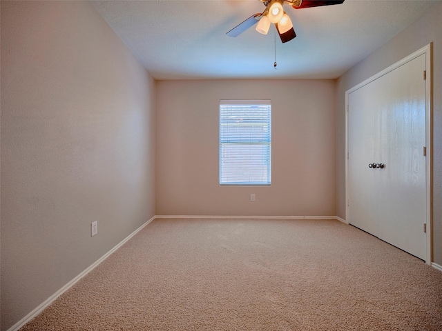 1122 Cotton Gum Ln, Rosenberg, TX 77471 - unfurnished bedroom with baseboards, a ceiling fan, and carpet