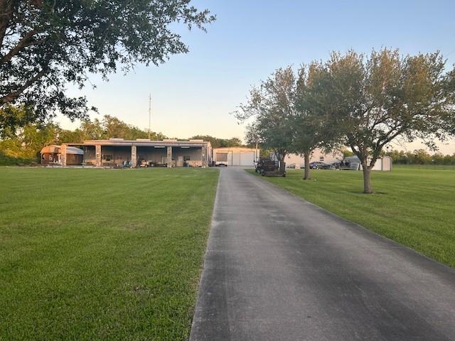 view of front of house with a front yard and a detached garage