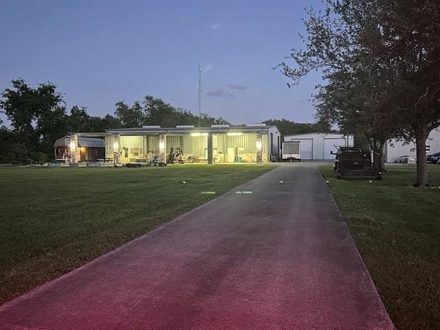 manufactured / mobile home featuring a front yard, an outdoor structure, and a garage