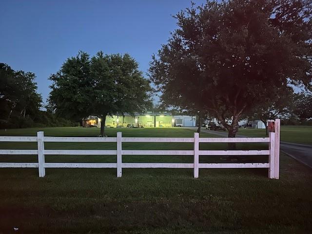 view of gate featuring a yard and fence
