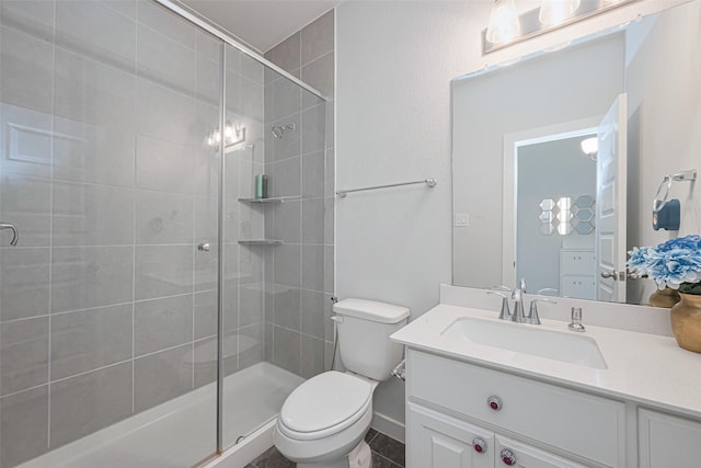full bathroom featuring toilet, a shower stall, and vanity