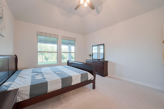 bedroom with light carpet, ceiling fan, baseboards, and lofted ceiling