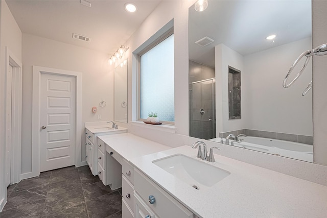 bathroom with double vanity, visible vents, a sink, and a stall shower