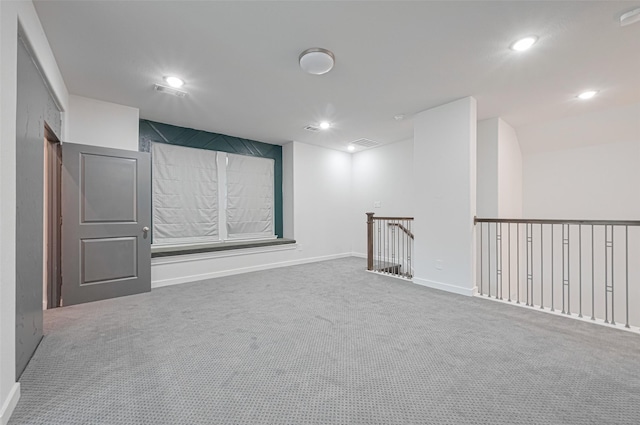 spare room with carpet flooring, visible vents, and recessed lighting