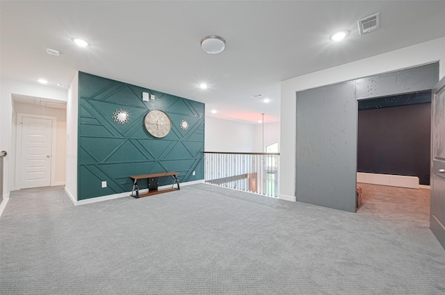 carpeted empty room with baseboards, visible vents, and recessed lighting