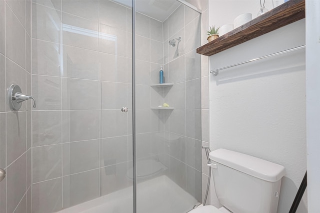 full bathroom featuring toilet and a shower stall