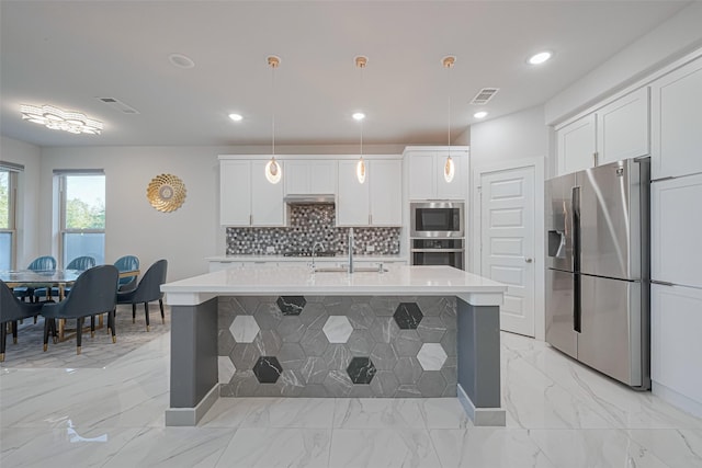 kitchen with stainless steel appliances, visible vents, light countertops, and a sink