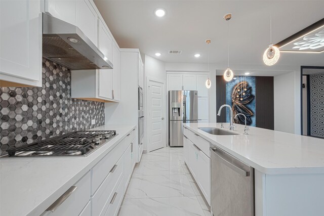 kitchen featuring visible vents, wall chimney exhaust hood, a kitchen island with sink, stainless steel appliances, and marble finish floor