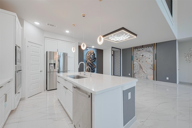 kitchen with visible vents, a center island with sink, stainless steel appliances, marble finish floor, and a sink