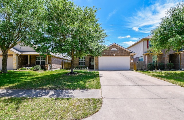 view of front of house with concrete driveway, fence, brick siding, an attached garage, and a front yard