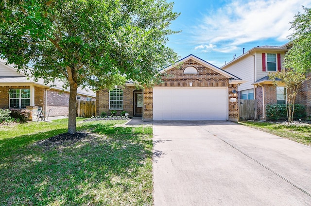 view of front of home with an attached garage, a front lawn, driveway, and fence