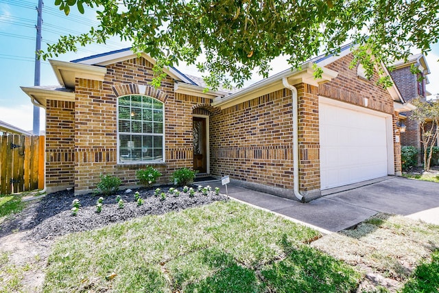 ranch-style house featuring brick siding, concrete driveway, a garage, and fence