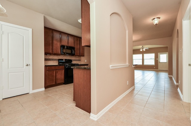 kitchen featuring arched walkways, tasteful backsplash, a ceiling fan, black appliances, and light tile patterned floors