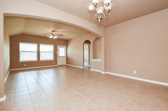 empty room with arched walkways, lofted ceiling, ceiling fan with notable chandelier, and light tile patterned floors