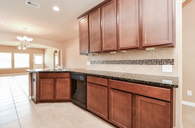kitchen with a peninsula, arched walkways, visible vents, a notable chandelier, and dishwasher