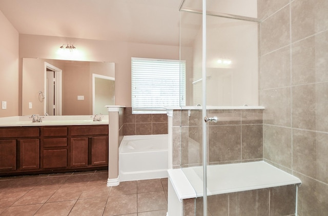 bathroom featuring a garden tub, tile patterned floors, double vanity, and tiled shower