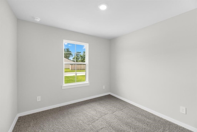 spare room featuring recessed lighting, baseboards, and carpet floors