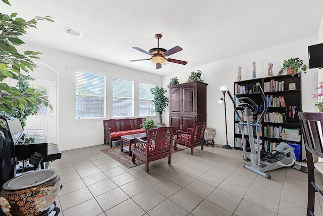 sitting room with visible vents, ceiling fan, light tile patterned floors, and baseboards