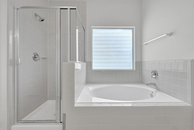 full bathroom with a garden tub and a stall shower