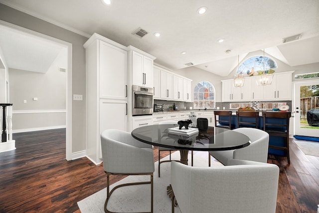 14102 Haynes Dr, Houston, TX 77069 - dining space with dark wood-style flooring, visible vents, baseboards, and vaulted ceiling